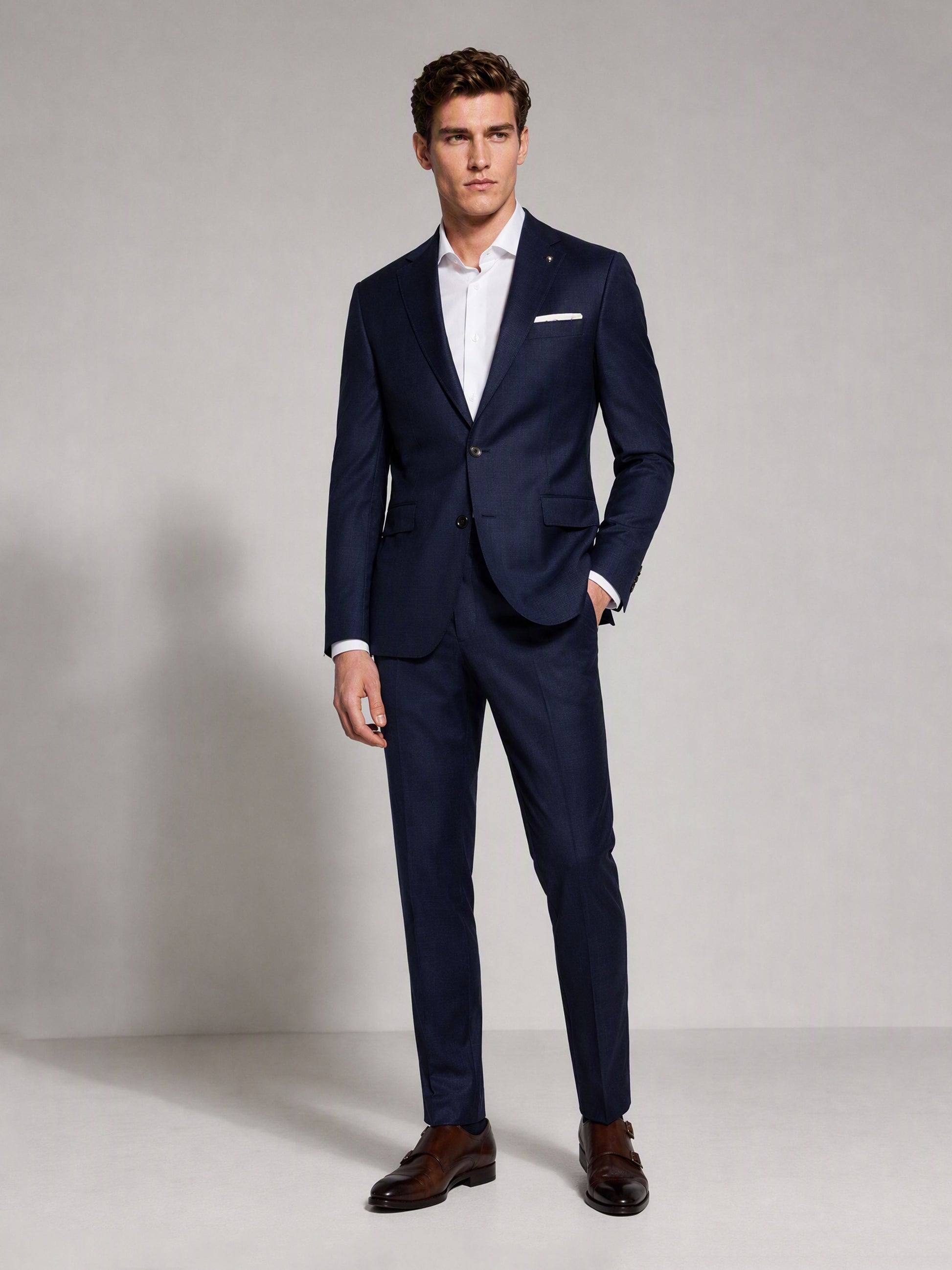 Savile navy blue business suit – full-length front view, hand in pocket showing slim fit silhouette