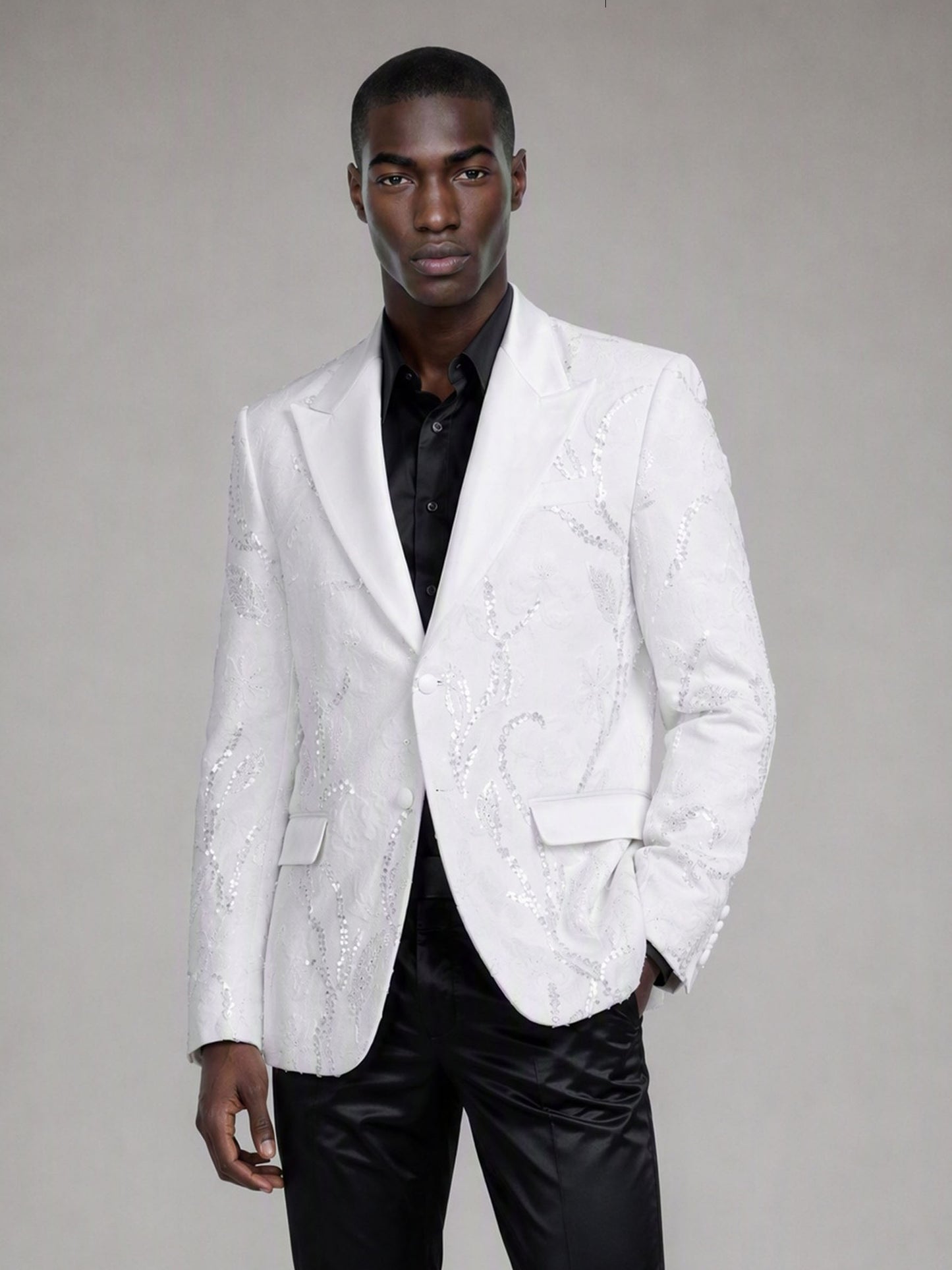 Savile white sequin floral suit – close-up upper body, silver-white sequin botanical embroidery and white peak lapel with silver brooch