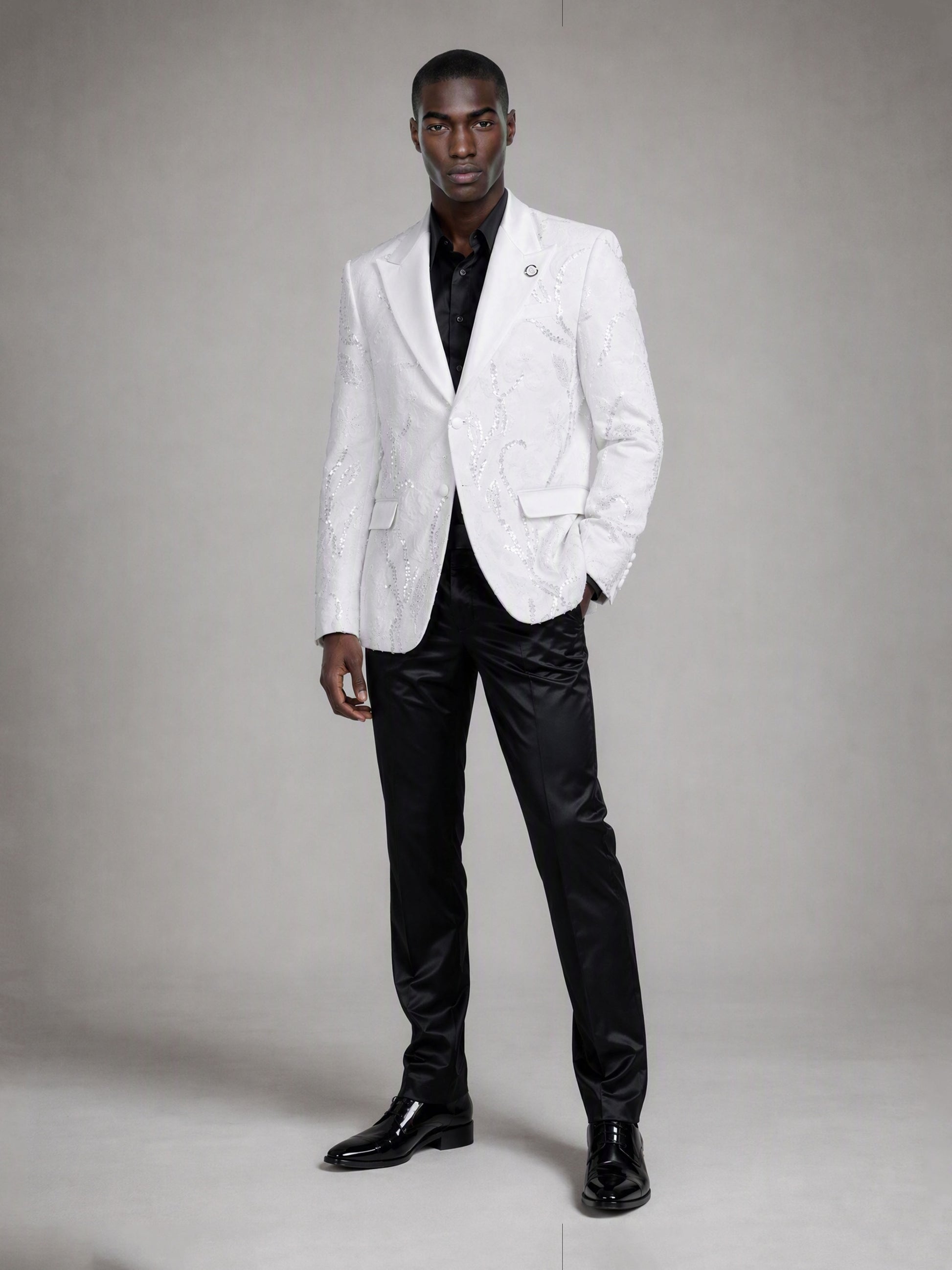 Savile white sequin floral suit – full-length front view, hand in pocket showing white-on-black contrast silhouette