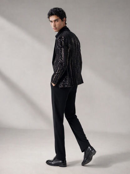 Savile black velvet sequin stripe suit – close-up face and upper body, silver sequin vertical stripes and black satin notch lapel detail