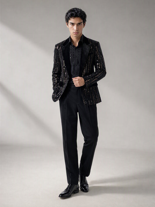 Savile black velvet sequin stripe suit – three-quarter side view, silver sequin stripes catching light and floral-beaded shirt detail