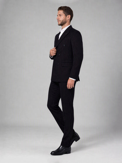Savile black velvet chalk stripe double-breasted suit – close-up upper body, wide peak lapels, badge pin and chalk stripe texture detail