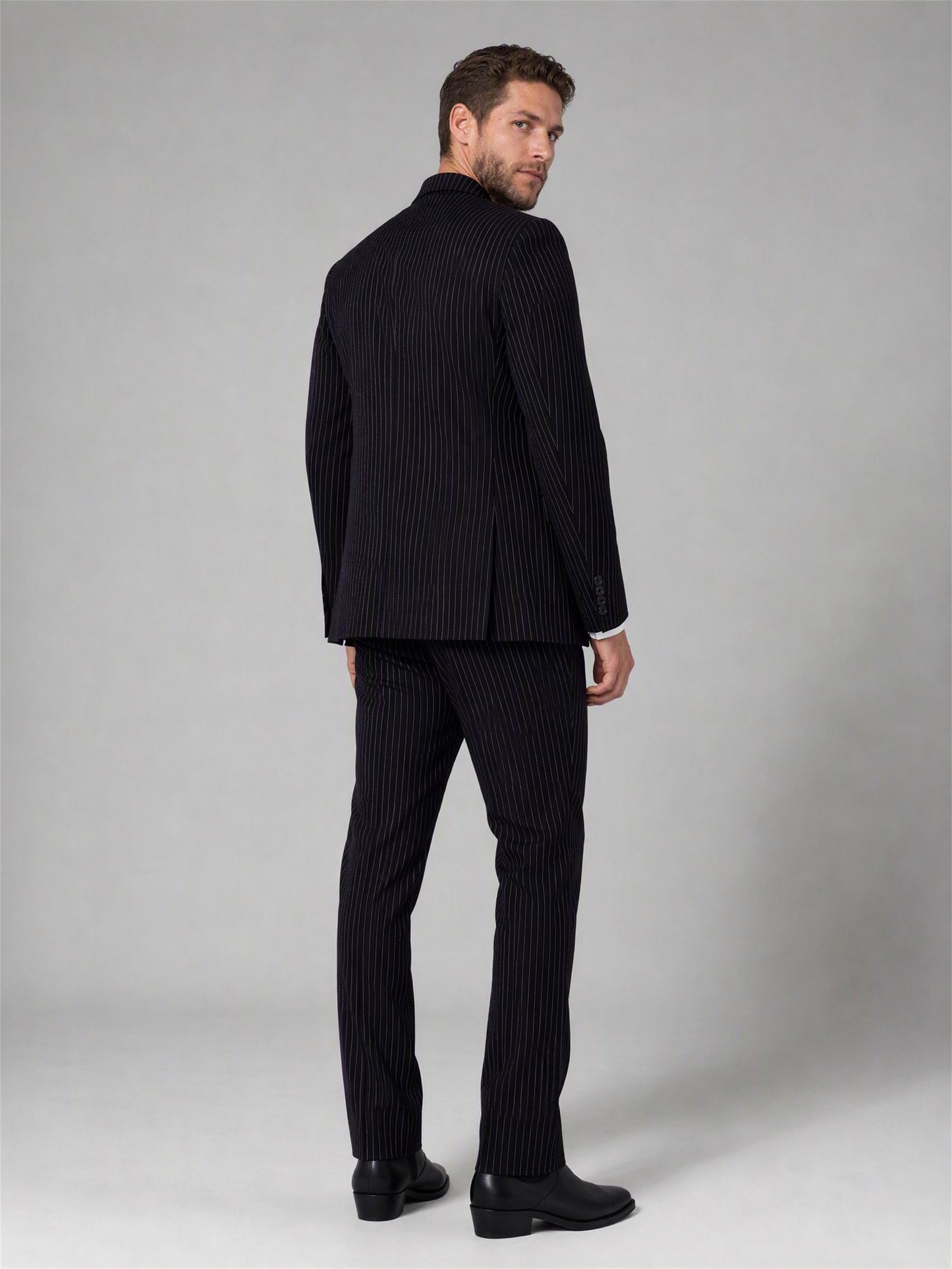 Savile black velvet chalk stripe double-breasted suit – back view showing center vent, chalk stripe pattern and tapered trouser