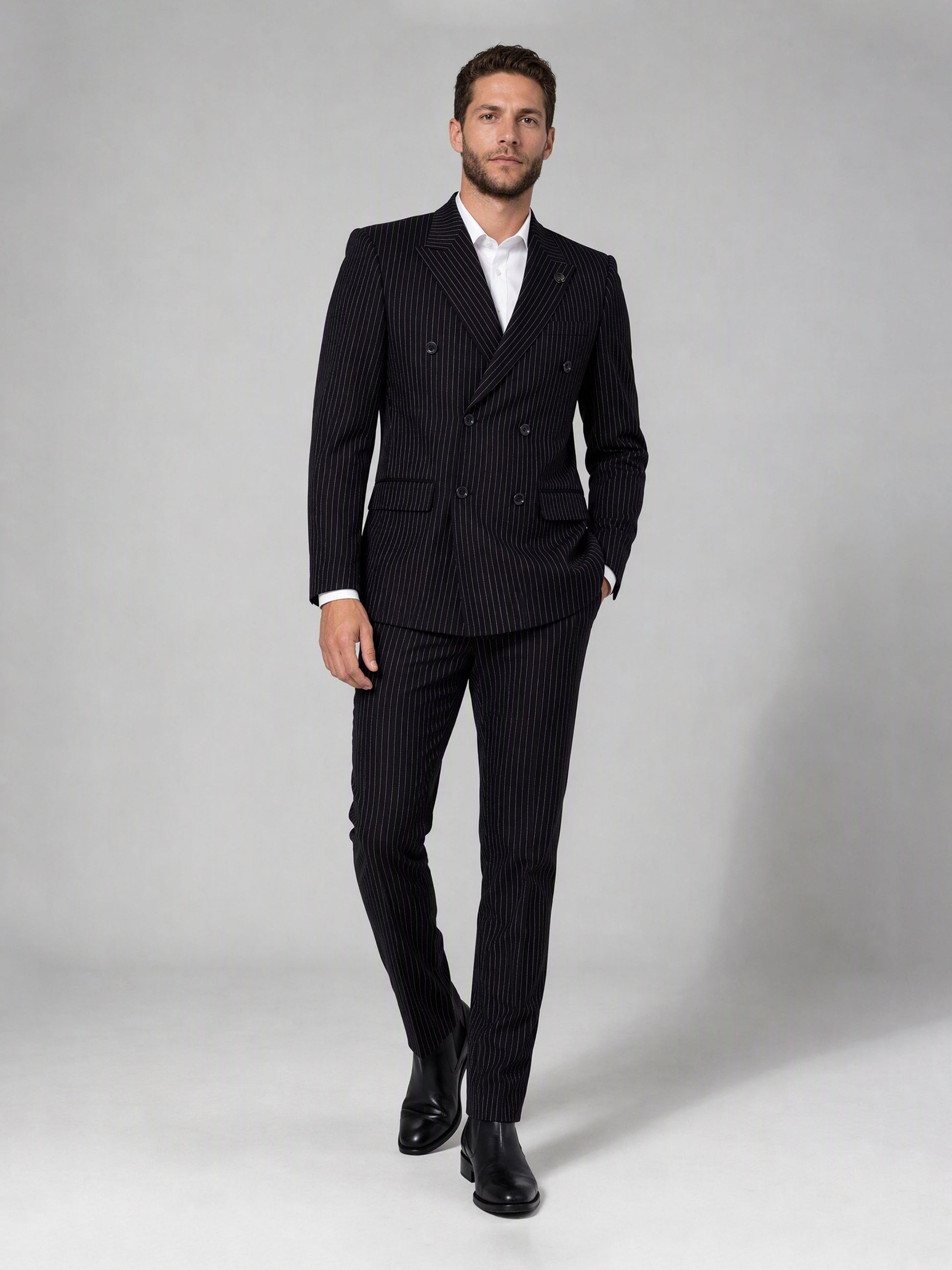 Savile black velvet chalk stripe double-breasted suit – full-length side walking shot showing chalk stripe trousers and Chelsea boots