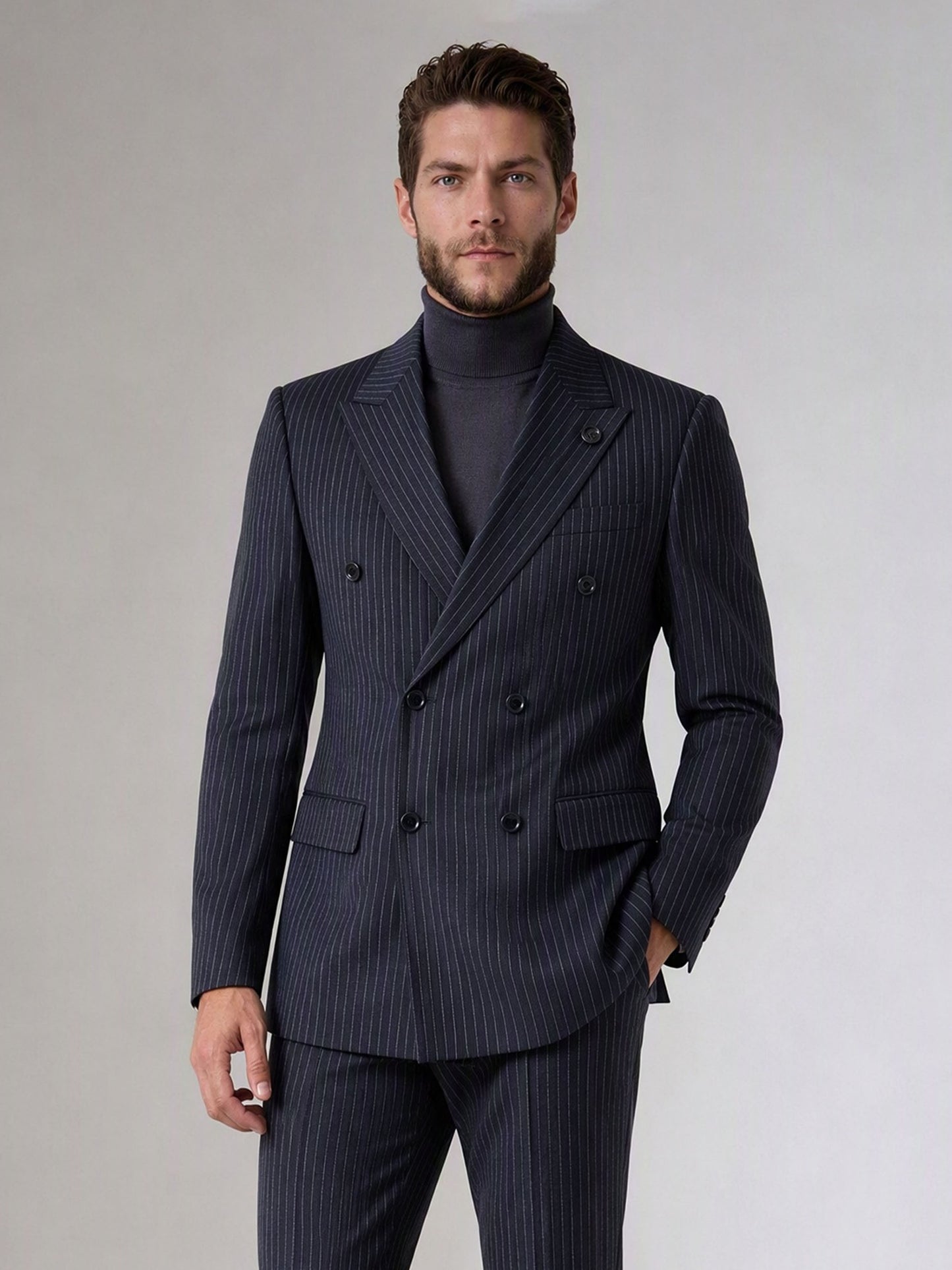 Savile navy blue chalk stripe double-breasted suit – full-length front view, hand in pocket showing complete chalk stripe silhouette