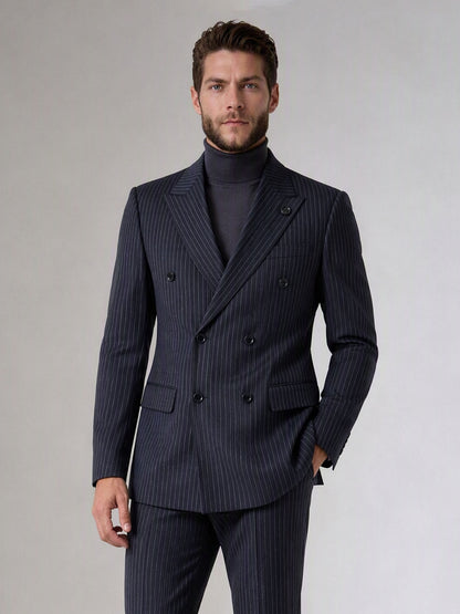 Savile navy blue chalk stripe double-breasted suit – full-length front view, hand in pocket showing complete chalk stripe silhouette