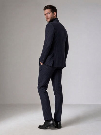 Savile navy blue chalk stripe double-breasted suit – full-length side walking shot showing chalk stripe trousers and black brogue oxfords