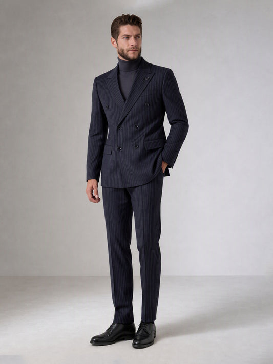 Savile navy blue chalk stripe double-breasted suit – back view showing center vent, chalk stripe pattern and tapered trouser silhouette