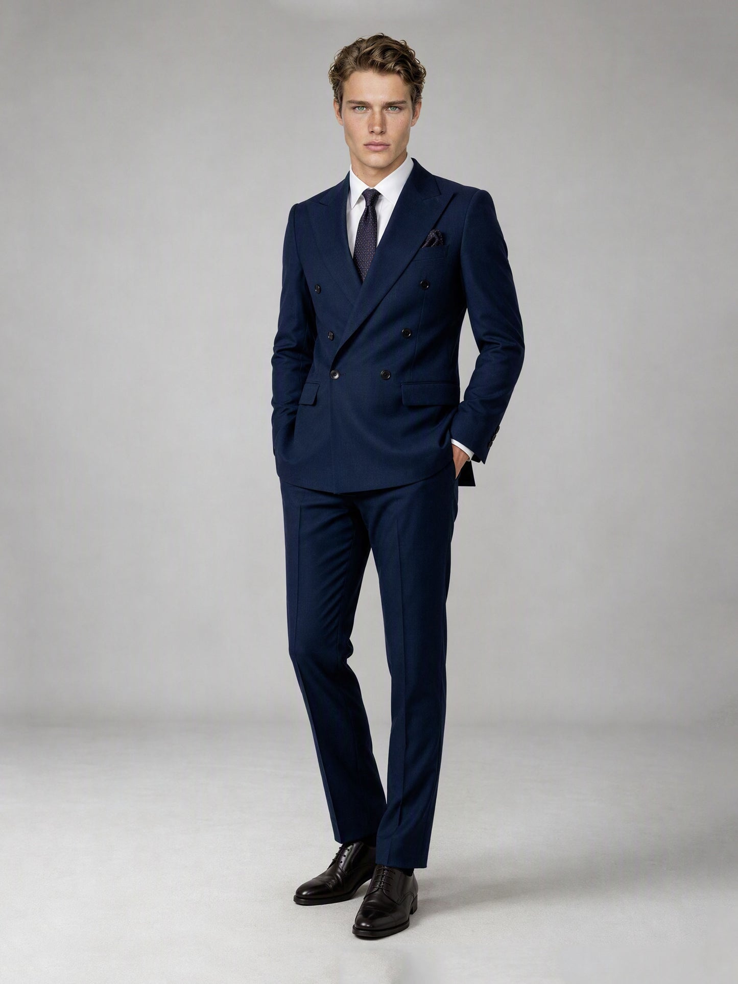 Savile deep navy double-breasted suit – full-length front view, one hand in pocket showing authoritative double-breasted silhouette