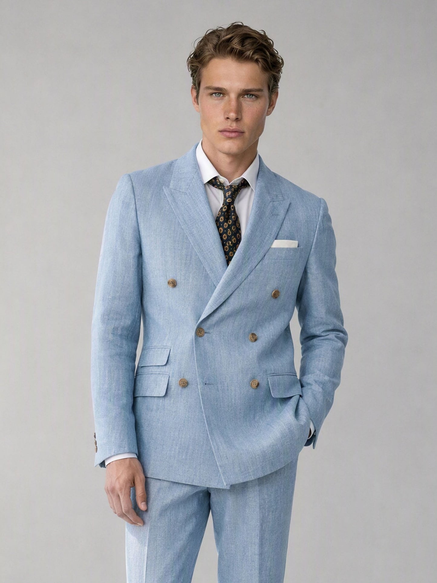Savile sky blue linen double-breasted suit – full-length front view, hand in pocket showing complete linen slim fit silhouette and brown tassel loafers