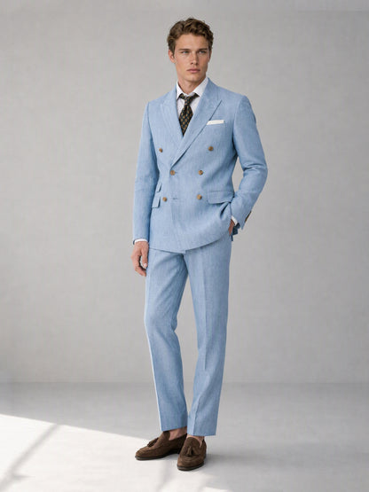 Savile sky blue linen double-breasted suit – close-up face and lapel, gold-tone buttons and linen texture detail with dark floral medallion tie