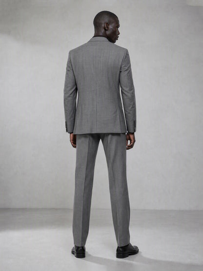 Savile grey wool blend suit – full-length front view, hand in pocket showing notch lapel and tapered trouser silhouette