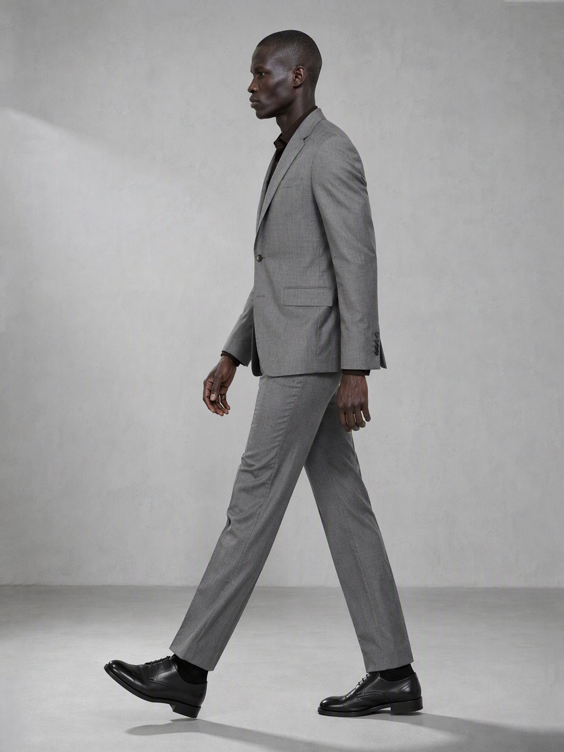 Savile grey wool blend suit – back view showing center vent, structured shoulder and clean tapered trouser silhouette