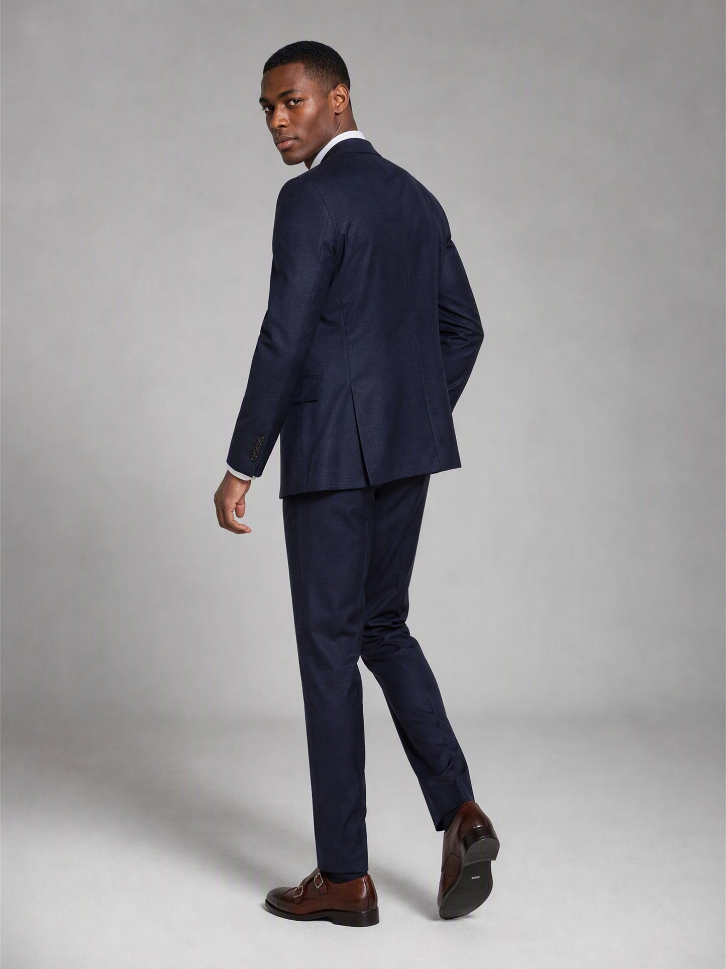 Savile deep navy slim fit suit – close-up upper body front, notch lapels, tonal navy buttons and white pocket square detail