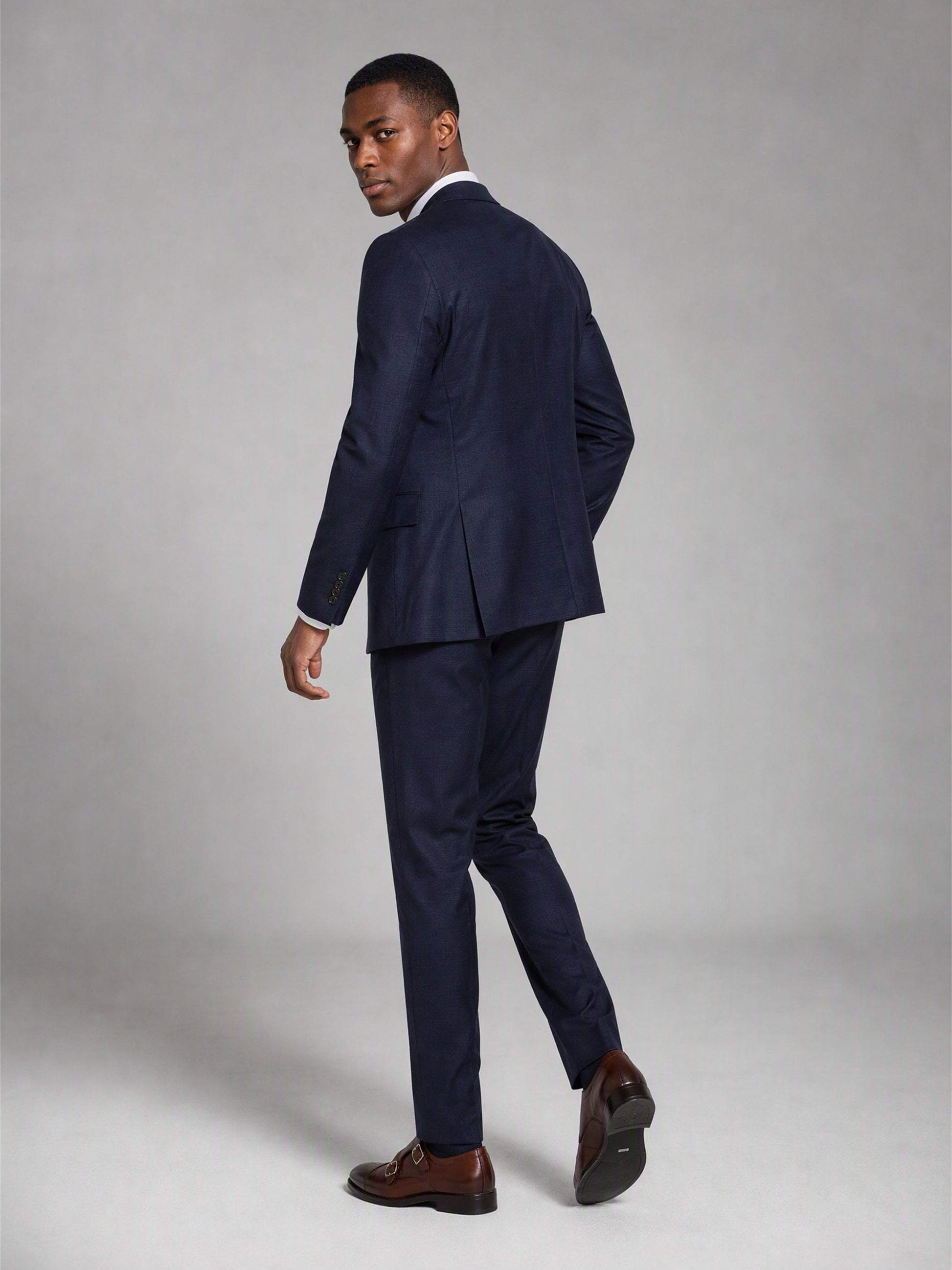 Savile deep navy slim fit suit – close-up upper body front, notch lapels, tonal navy buttons and white pocket square detail