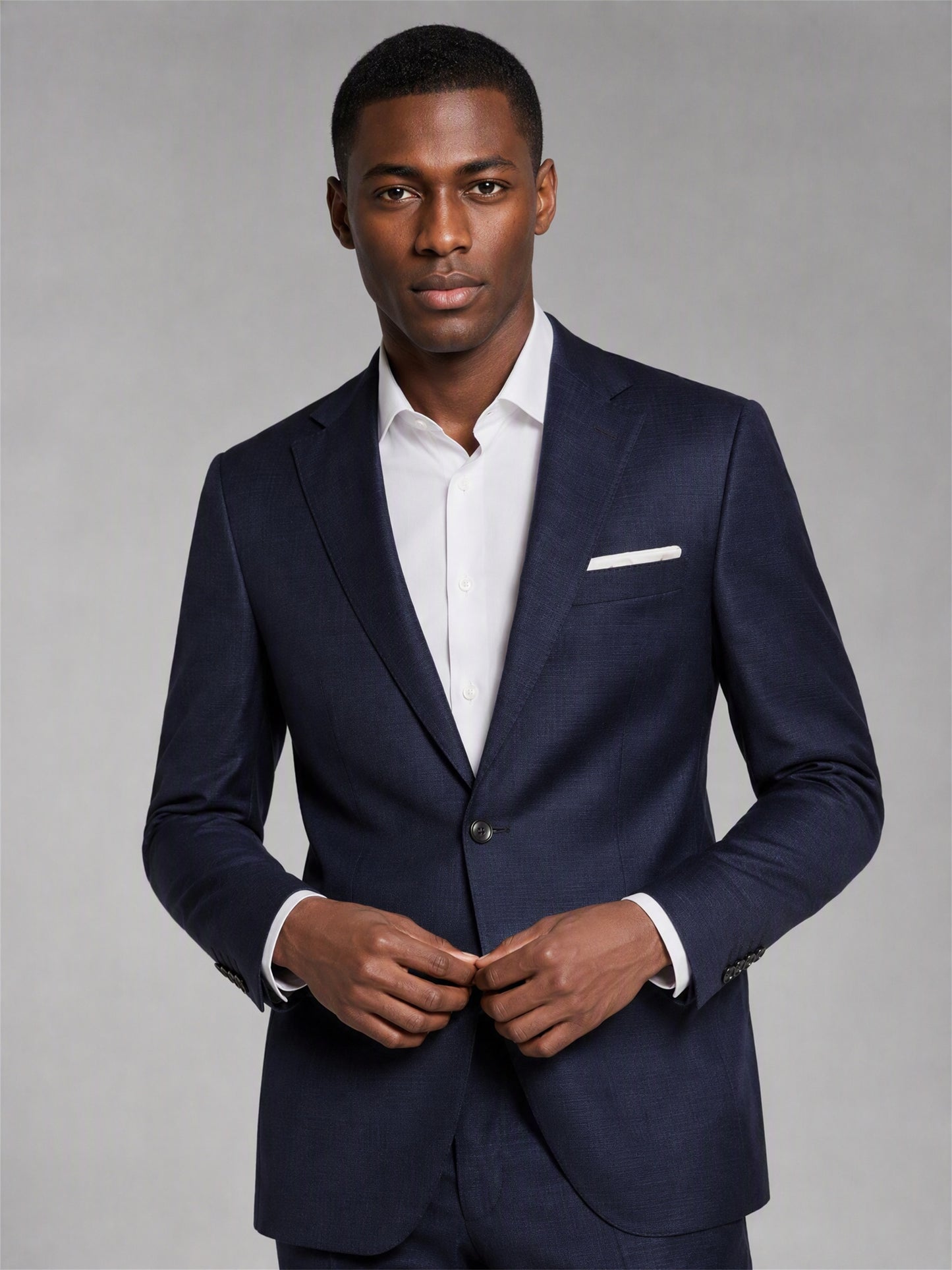 Savile deep navy slim fit suit – full-length front view, hand in pocket showing notch lapel and tapered trouser silhouette