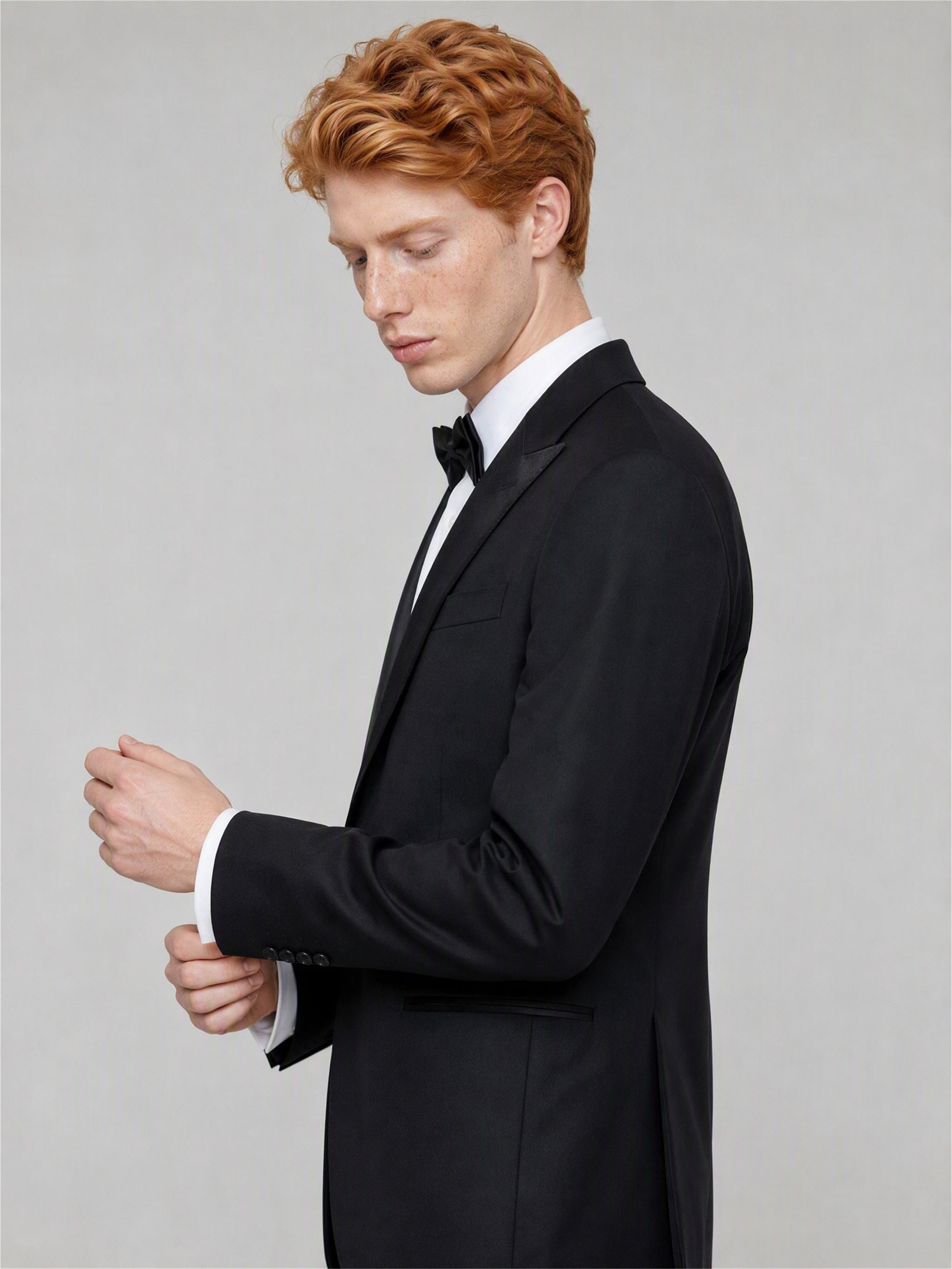 Savile GA0132 black tuxedo suit - upper body close-up showing satin peak lapel and bow tie styling