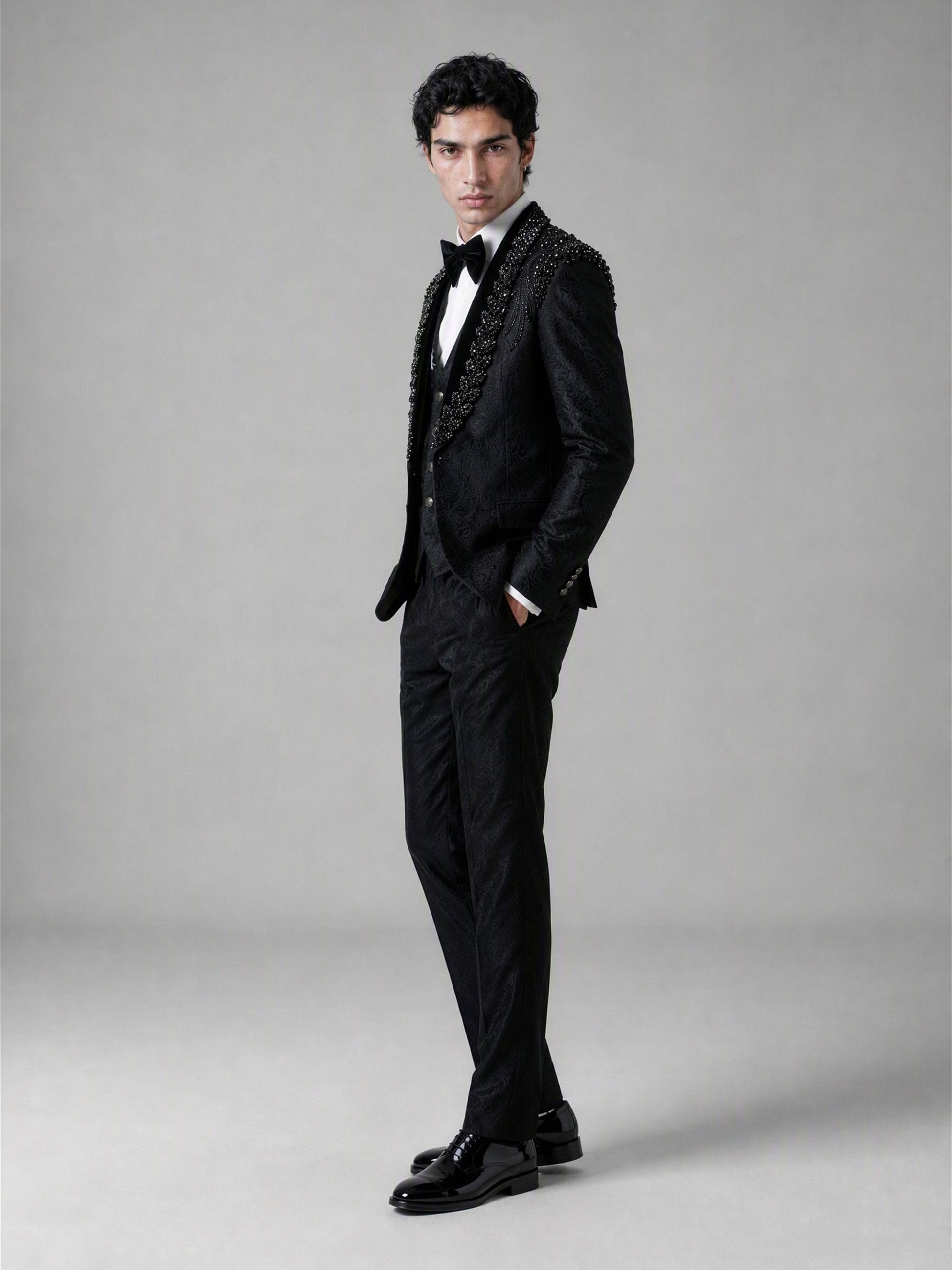 Savile GA0141 black jacquard tuxedo suit - upper body close-up showing crystal and jet bead shoulder embellishment cascading across peak lapel