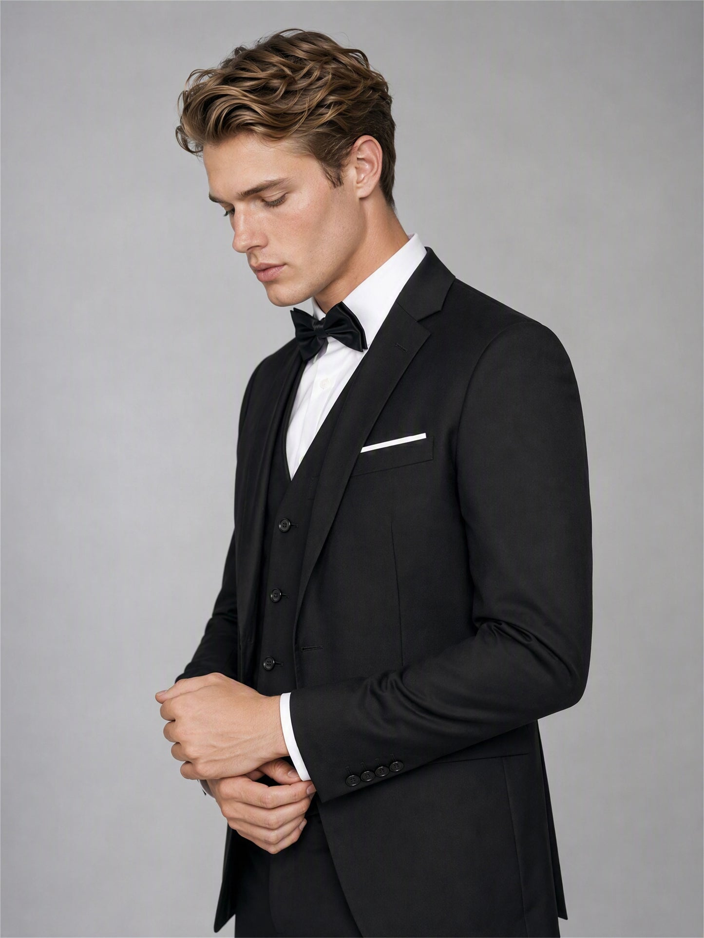 Savile GA0142 black 4-piece suit - full front view showing single-breasted peak lapel jacket with vest, bow tie and white pocket square