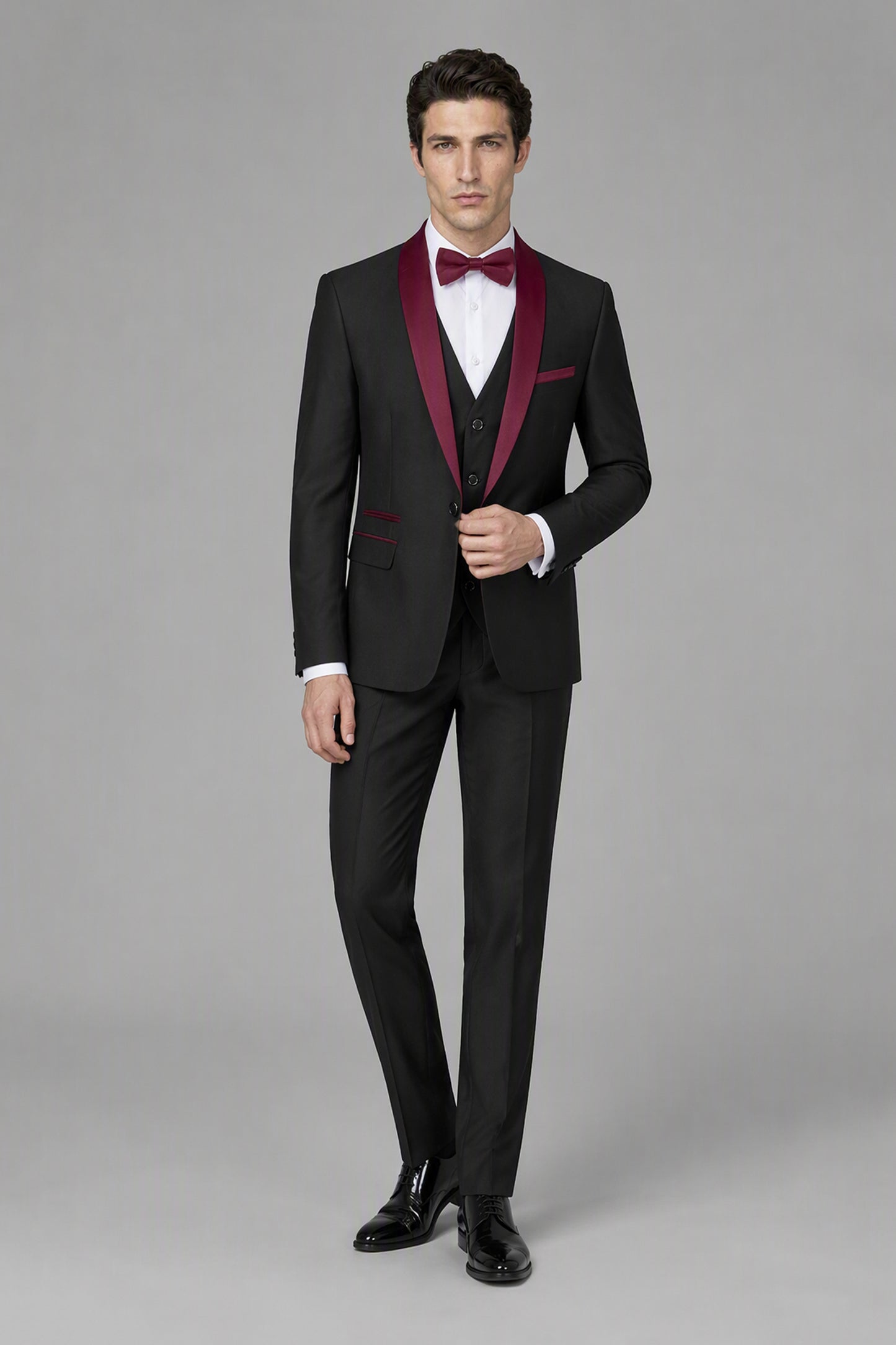 Savile Black & Burgundy 3-Piece Tuxedo Set – Three-quarter front view, model holding jacket open to show vest detail