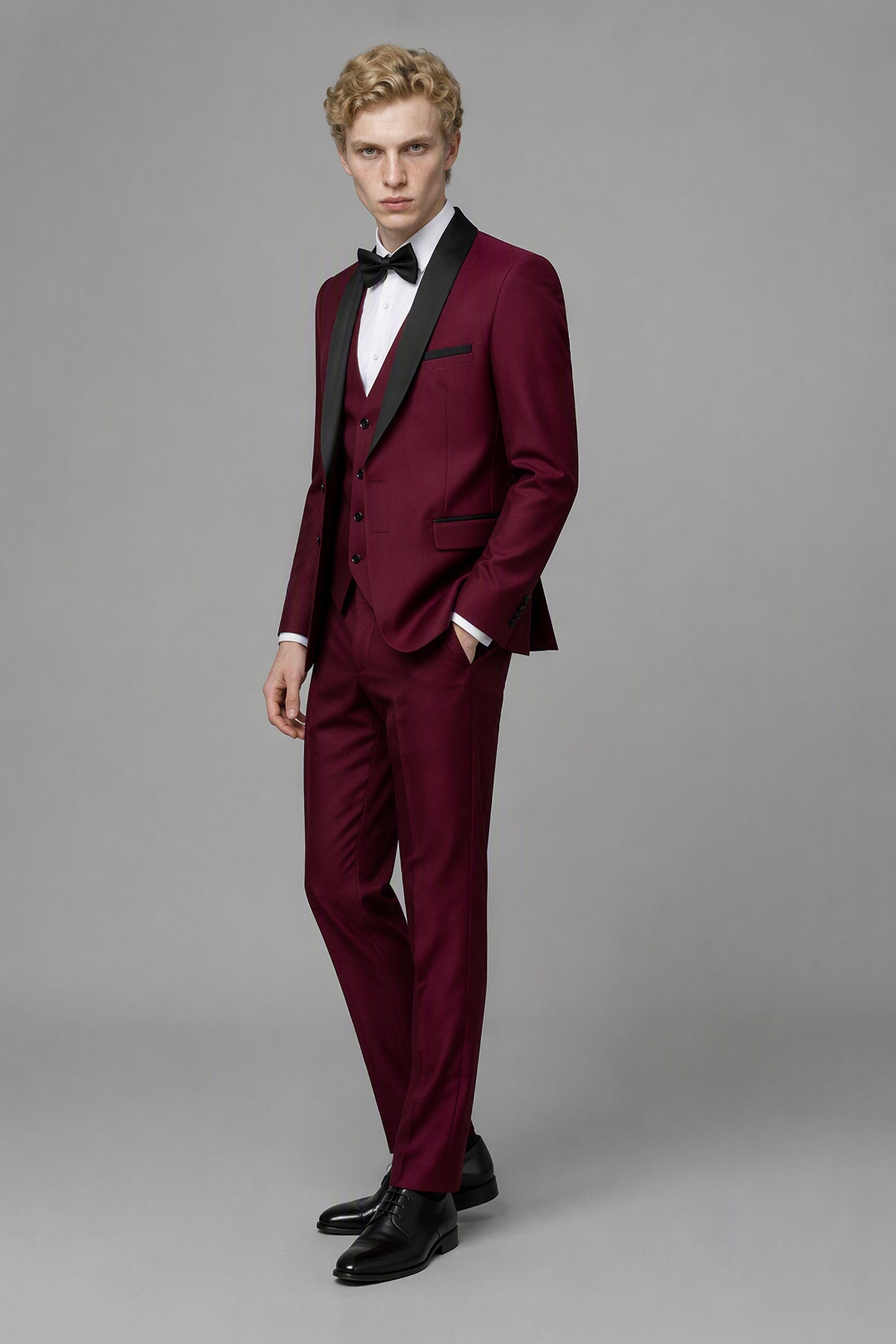 Savile Burgundy 3-Piece Tuxedo Set – Three-quarter front view with hands in pockets showing slim-fit silhouette