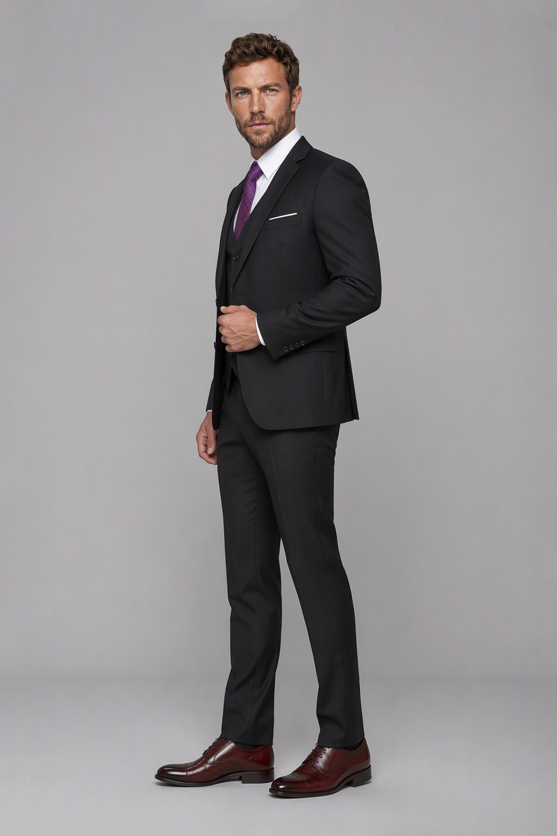Savile Black 3-Piece Suit Set – Three-quarter front view, second model hand in pocket showing structured shoulder and slim silhouette