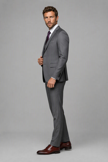 Savile Grey 3-Piece Suit Set – Three-quarter side view, model adjusting jacket showing lapel profile and structured shoulder