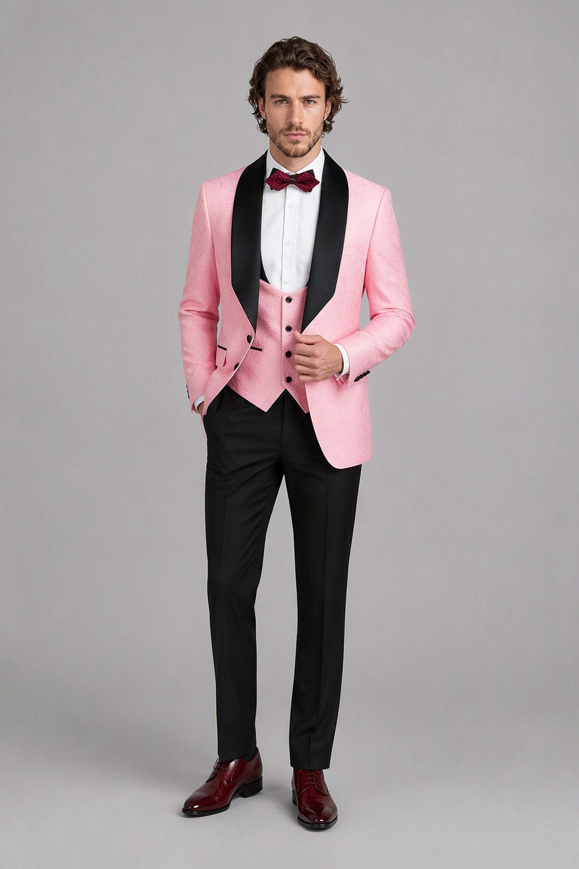 Savile Pink Jacquard 3-Piece Tuxedo Set – Full front walking view showing pink jacquard jacket, vest, white shirt and black trousers with burgundy oxford shoes
