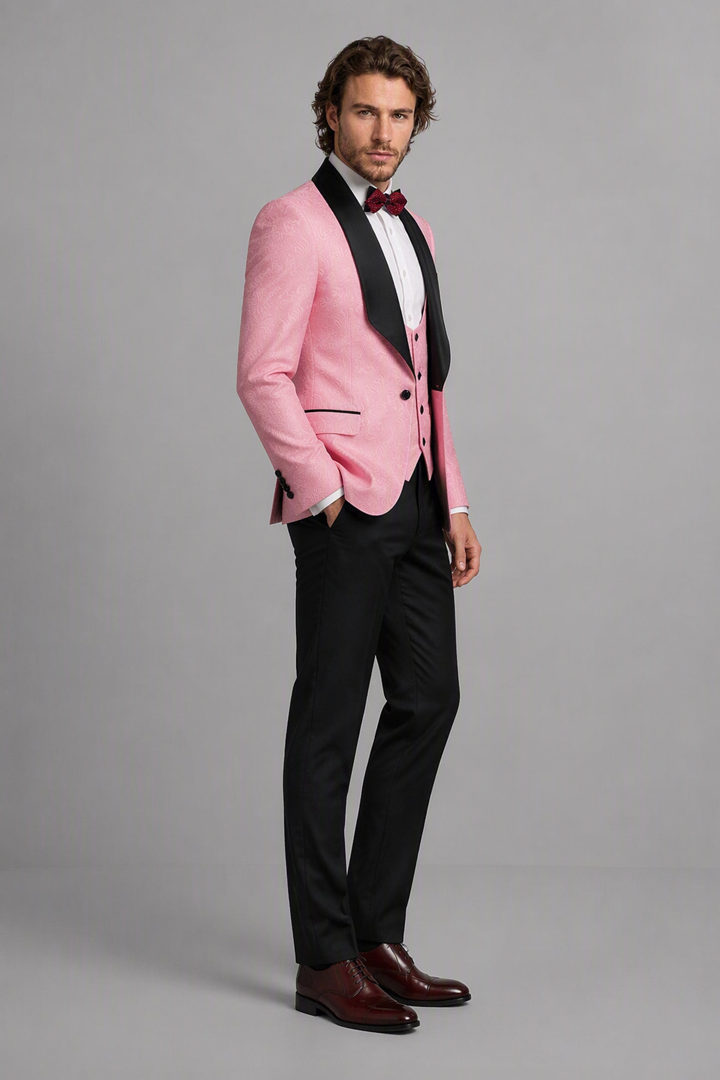 Savile Pink Jacquard 3-Piece Tuxedo Set – Full front standing view, model adjusting jacket showing slim-fit silhouette and black satin shawl lapel