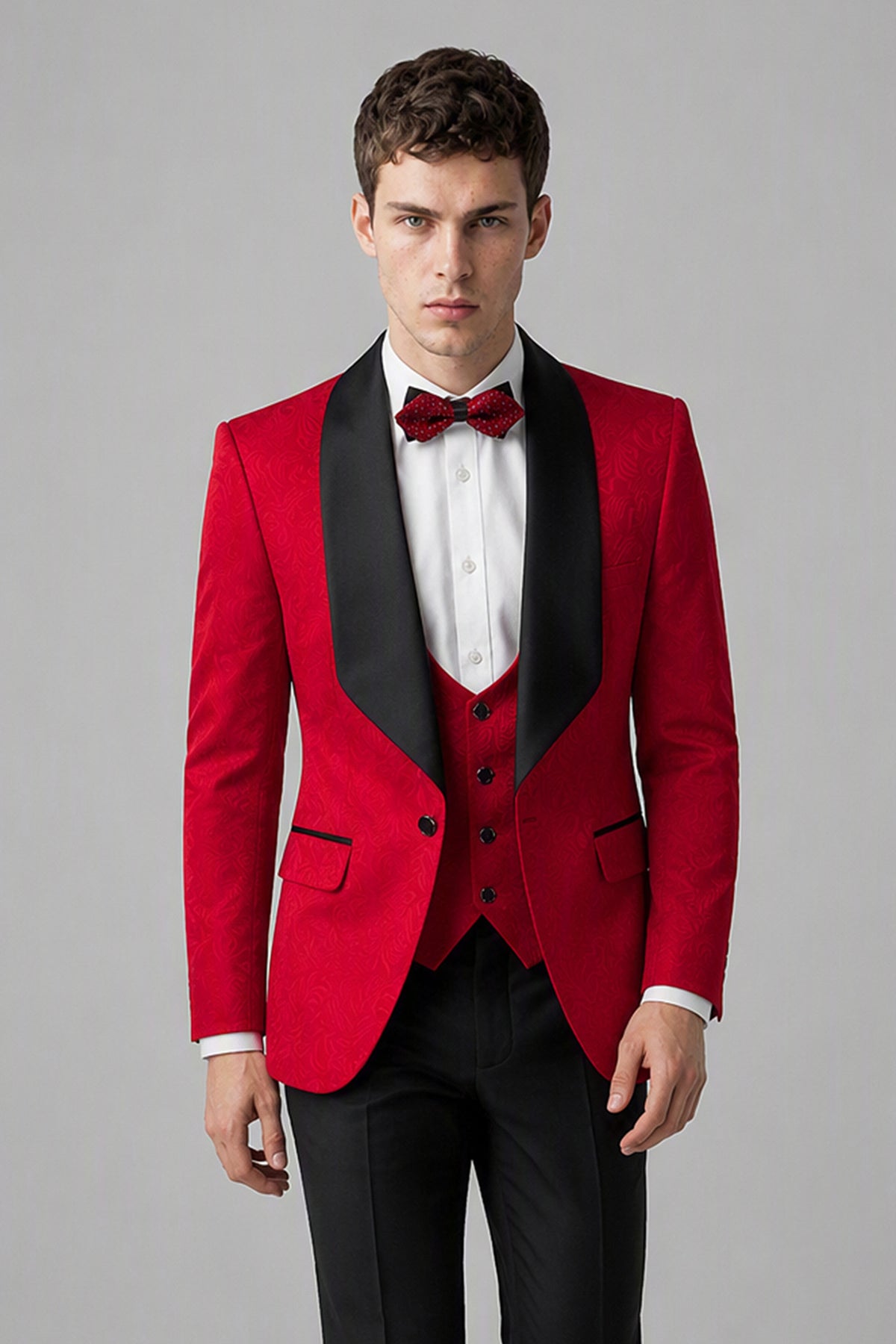 Savile Red 3-Piece Tuxedo Set – Three-quarter side view, model holding jacket showing slim silhouette, red body and black satin lapel profile