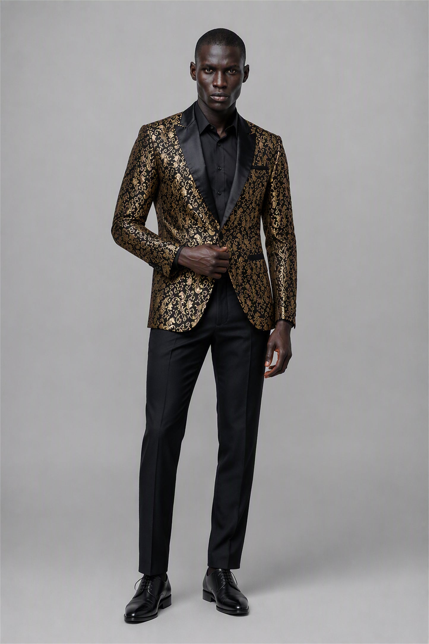Savile Black & Gold Jacquard Tuxedo Jacket – Half-body front close-up showing baroque gold jacquard texture, black satin peak lapel and black trim detail