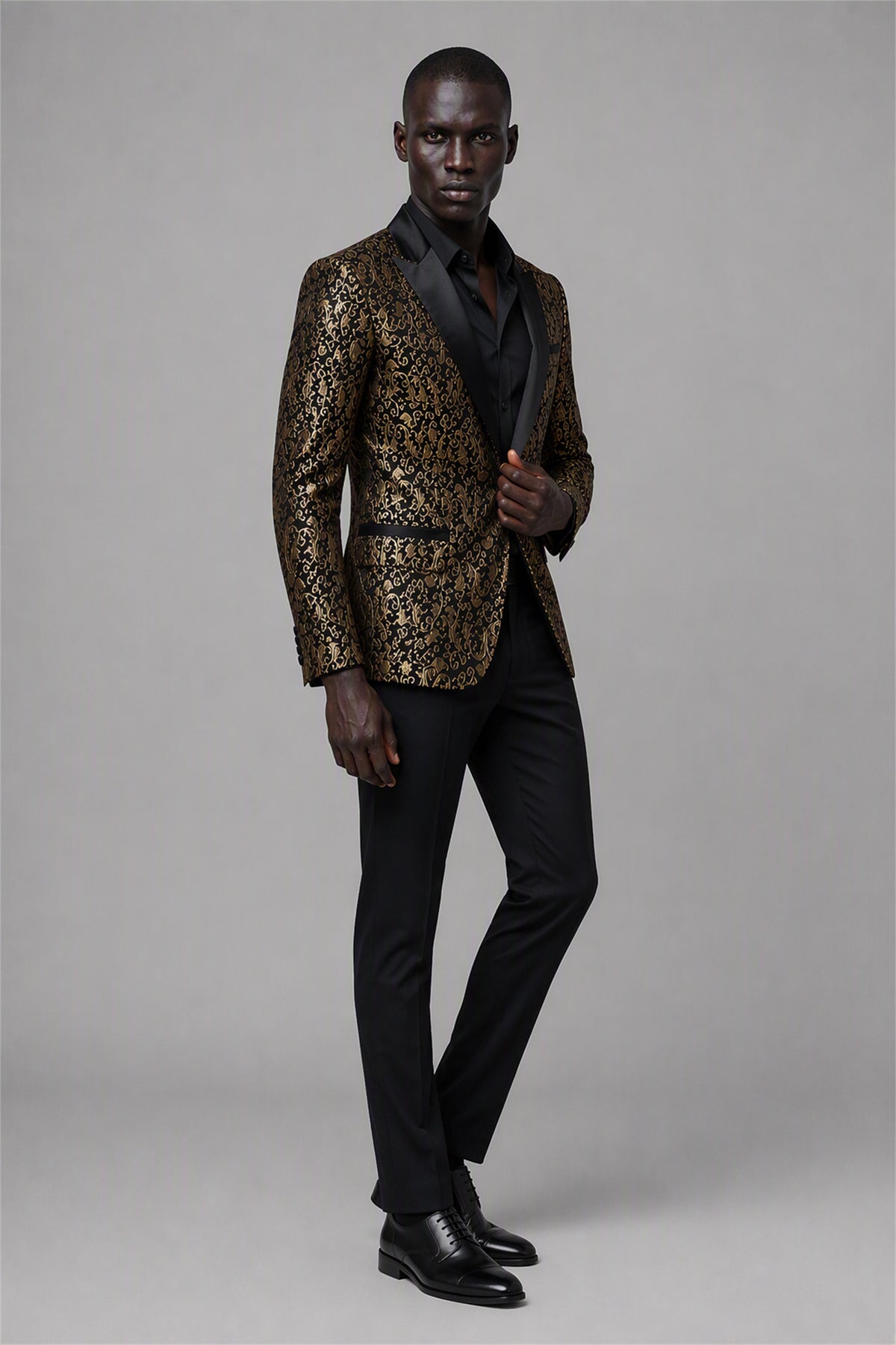 Savile Black & Gold Jacquard Tuxedo Jacket – Full front walking view showing natural drape, gold jacquard body and tapered black trouser fit
