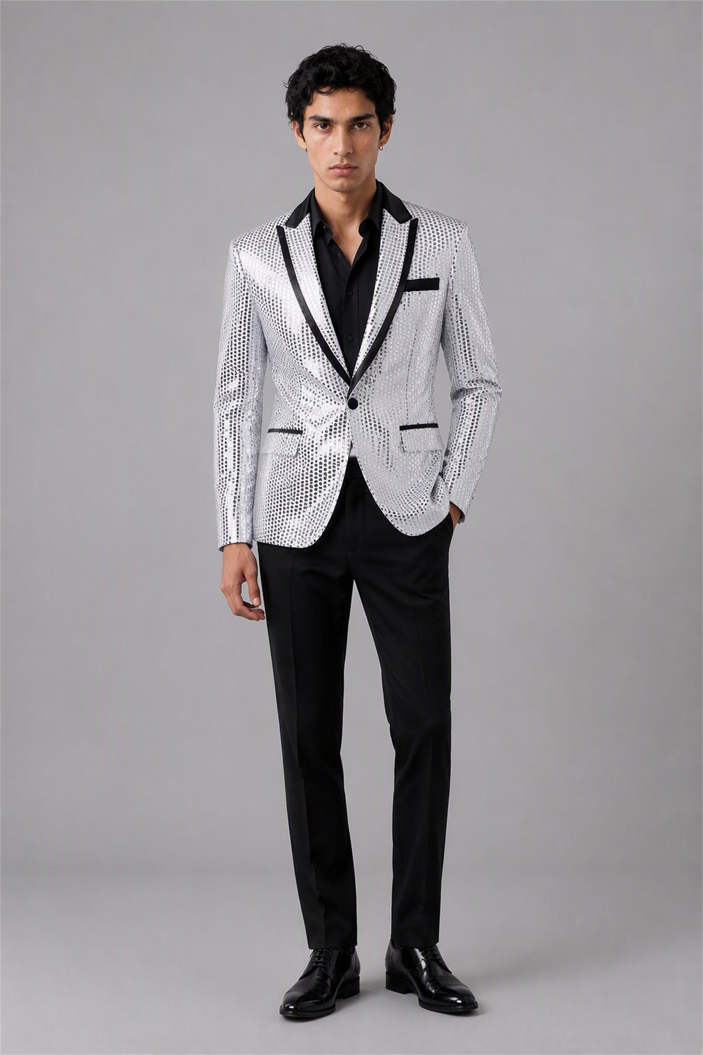 Savile Silver Sequin Tuxedo Jacket – Full side standing view showing slim silhouette, silver sequin body and black satin peak lapel profile