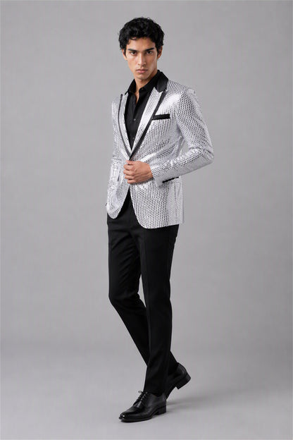 Savile Silver Sequin Tuxedo Jacket – Half-body front close-up showing mirror silver sequin embellishment, black satin peak lapel and pocket trim detail