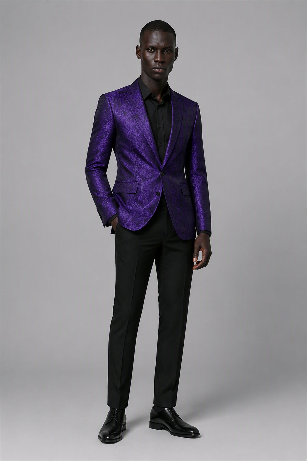 Savile Purple Paisley Jacquard Tuxedo Jacket – Full front standing view, hand in pocket showing slim-fit silhouette and purple paisley jacquard with black satin lapel