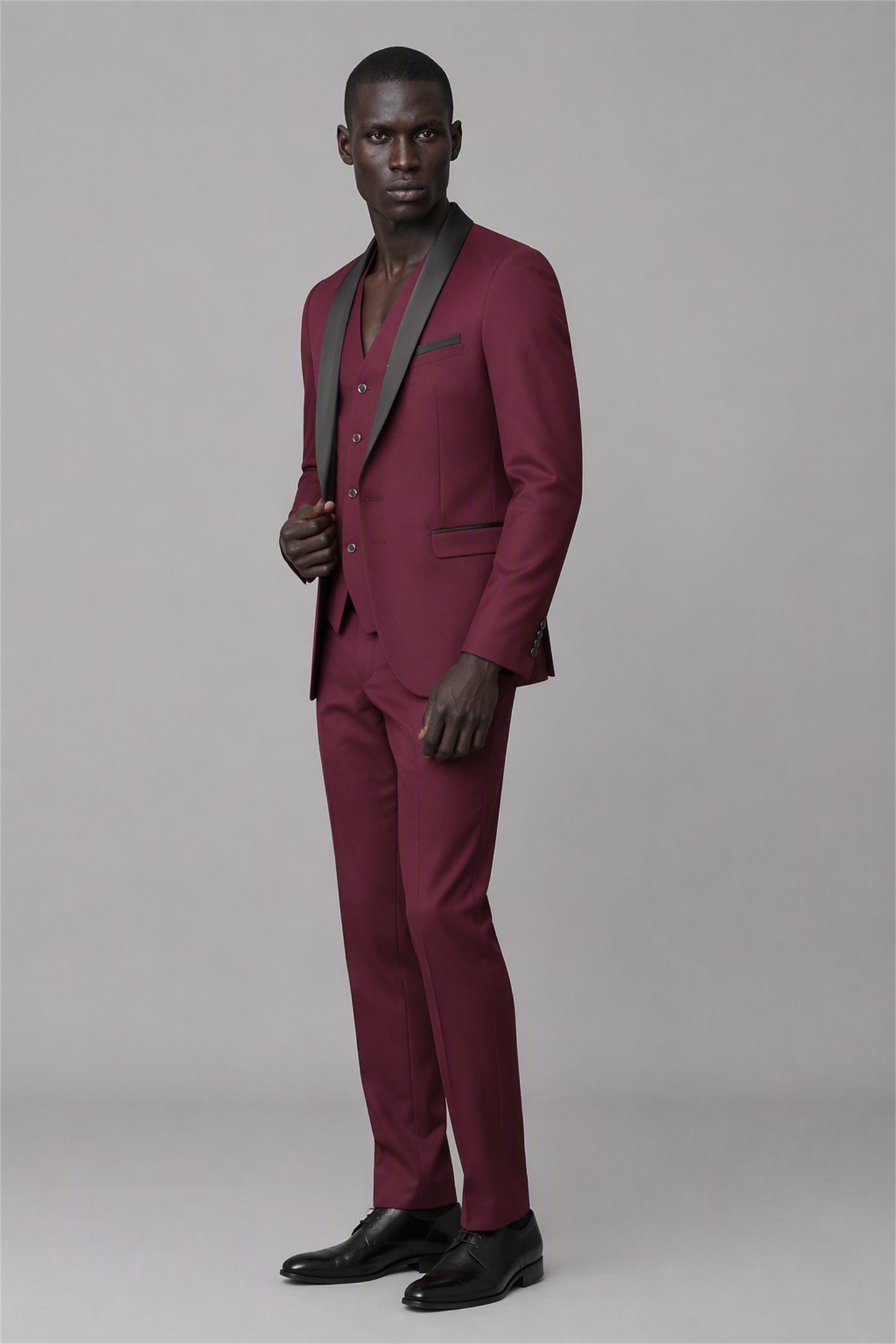 Savile Burgundy 3-Piece Tuxedo Set – Full rear three-quarter view showing burgundy jacket back construction, black satin shawl lapel edge and tapered trouser fit