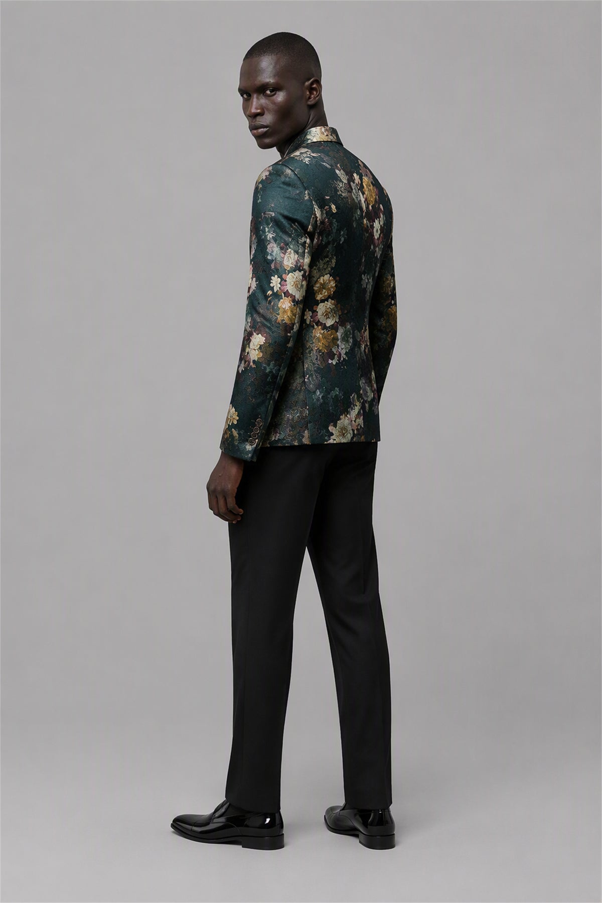 Savile Emerald Green Floral Jacquard Blazer – Full side profile view with white tee showing slim silhouette, hand on lapel, emerald floral texture and notch lapel profile