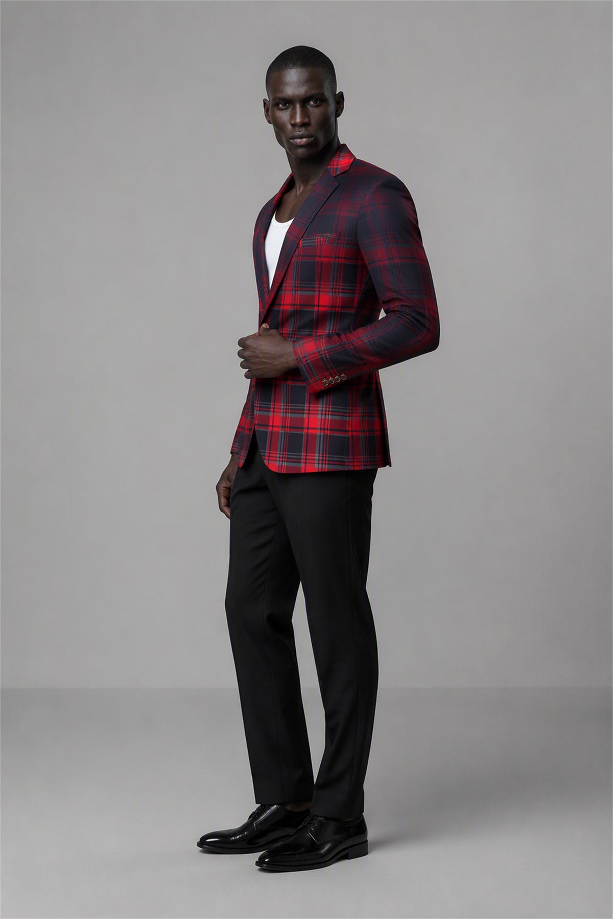 Savile Red & Black Plaid Blazer – Full rear three-quarter view with white tee showing red black tartan back construction, structured shoulders and tapered black trouser fit