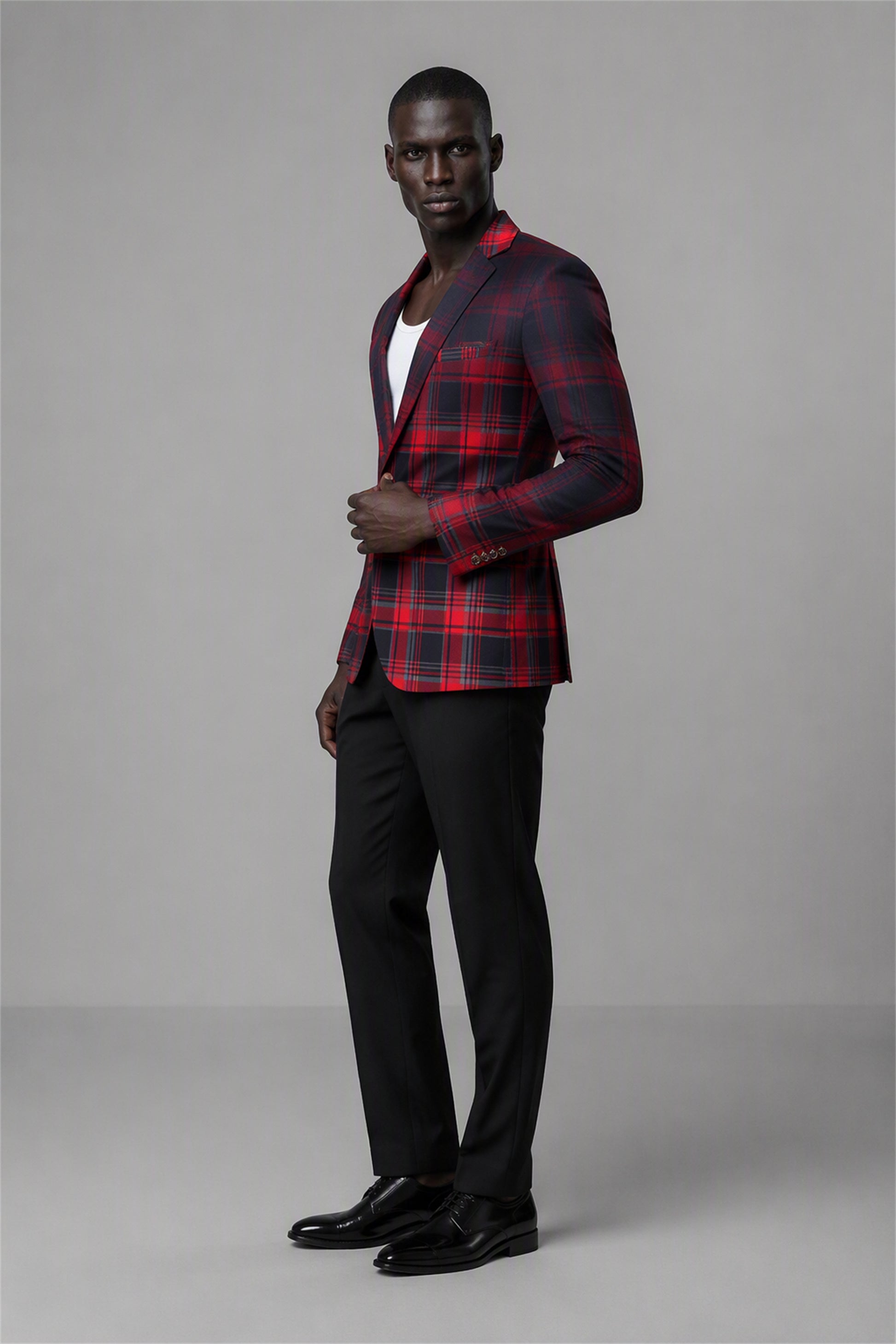 Savile Red & Black Plaid Blazer – Full rear three-quarter view with white tee showing red black tartan back construction, structured shoulders and tapered black trouser fit