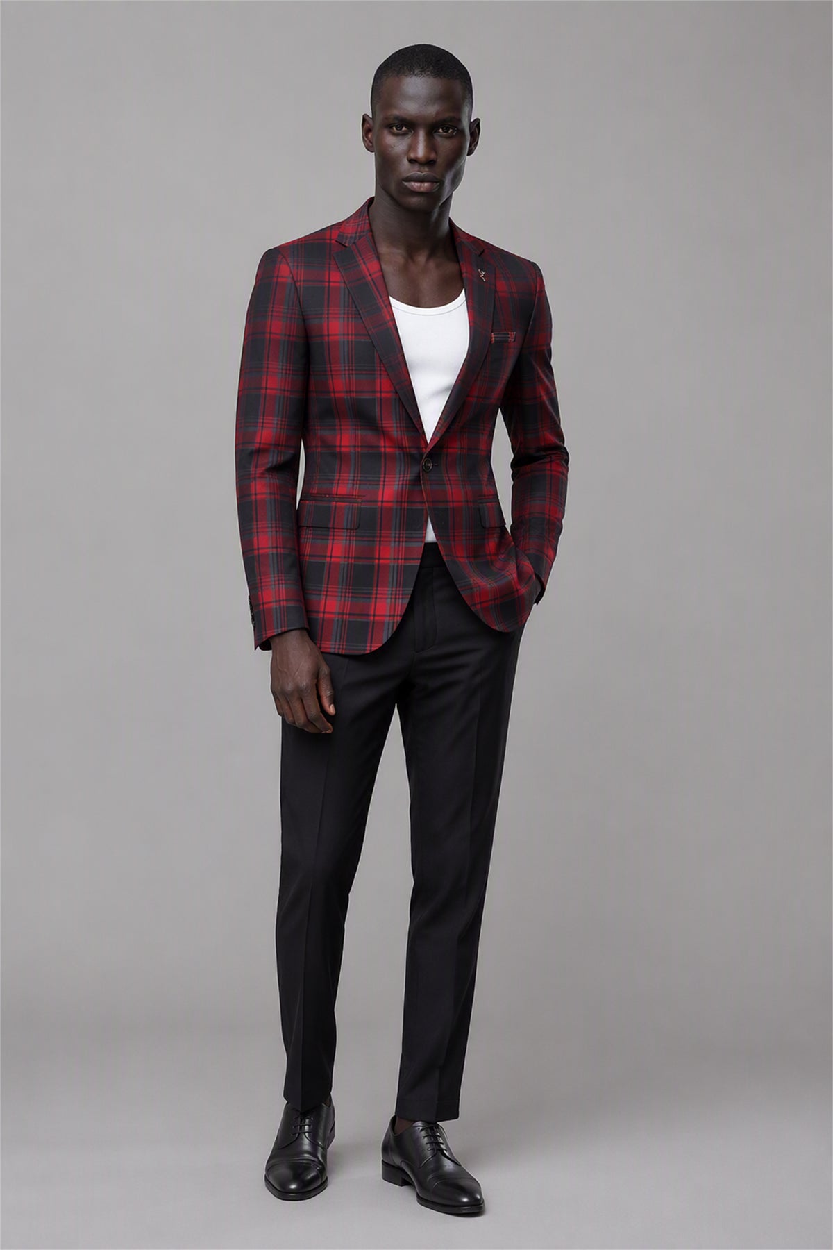 Savile Red & Black Plaid Blazer – Three-quarter side view with white tee showing slim-fit silhouette, red tartan texture and black notch lapel profile