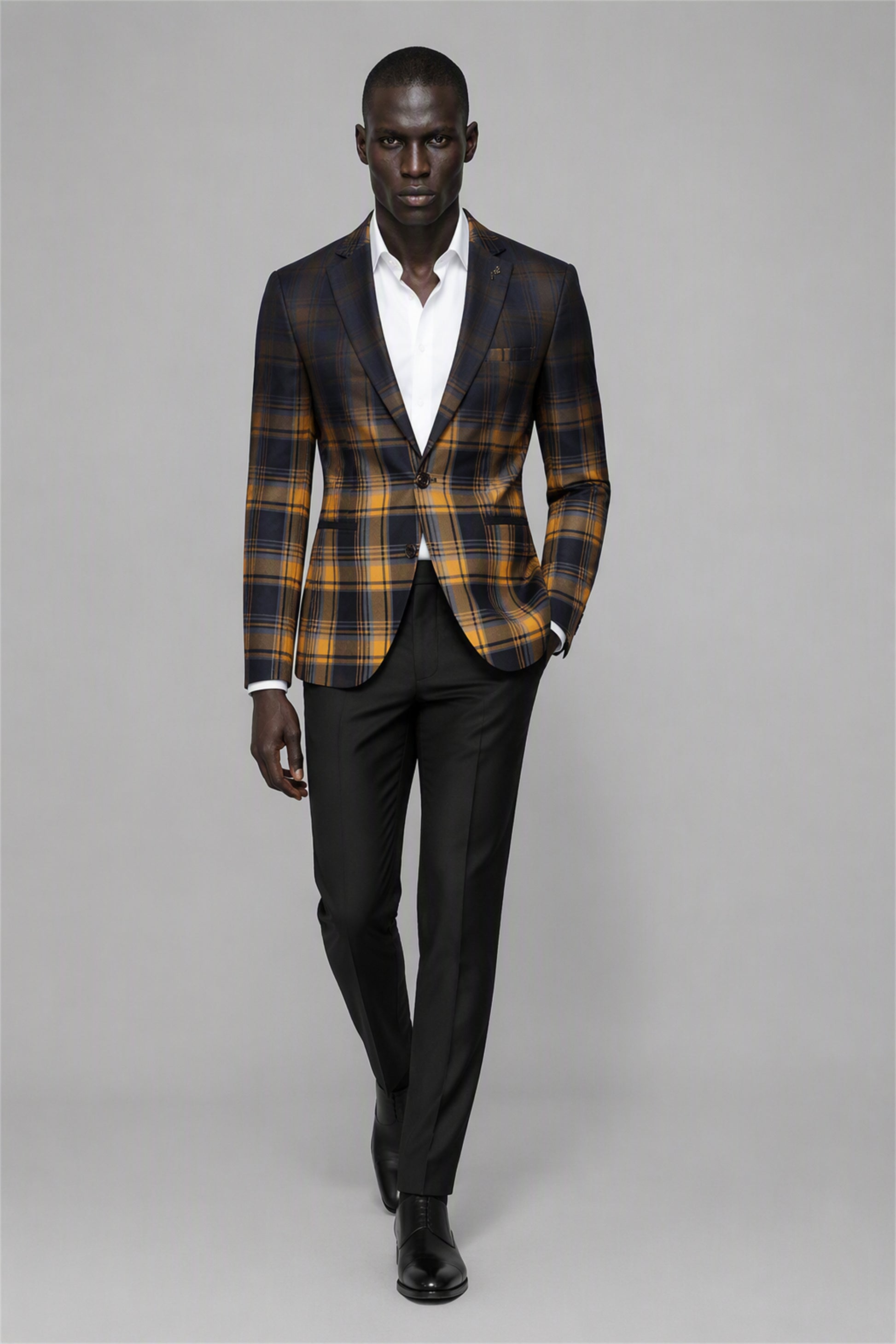 Savile Amber Gold & Navy Tartan Blazer – Half-body front close-up showing amber gold and navy tartan check pattern, black notch lapel, white pocket square and brooch pin