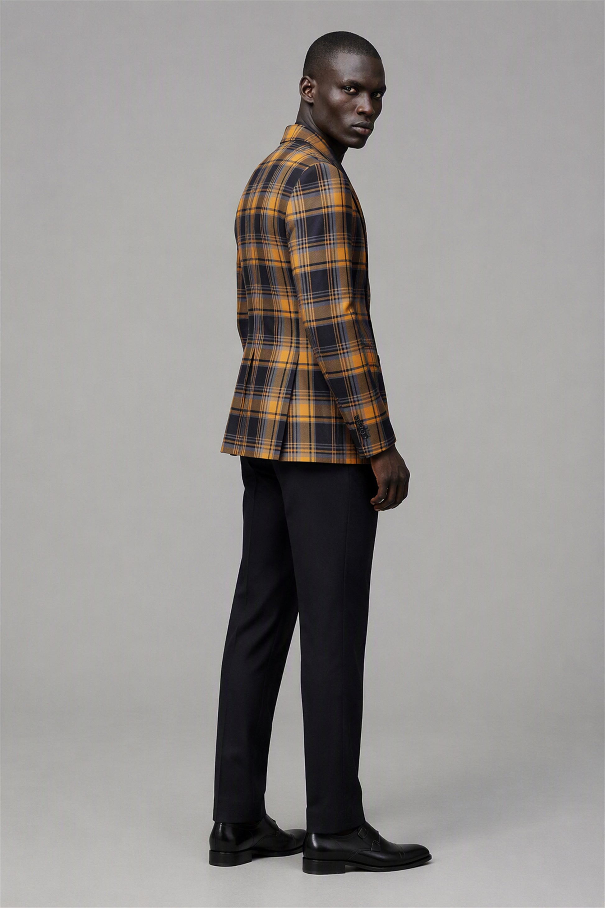 Savile Amber Gold & Navy Tartan Blazer – Full front walking view showing complete look with amber gold tartan blazer, white shirt and black trousers with black oxford shoes